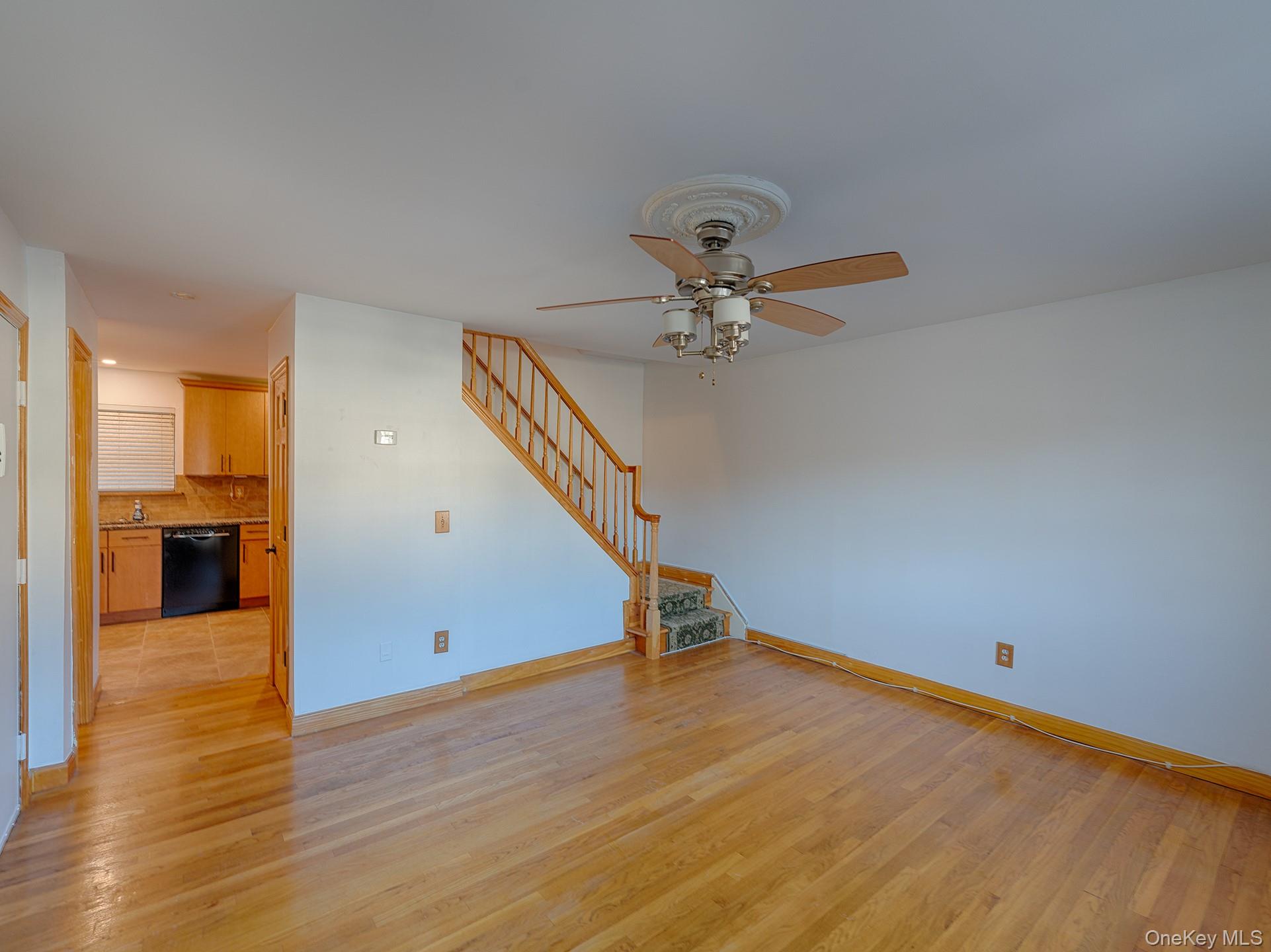4 Forge Gate Drive, Unit F2B Cold Spring, NY 10516 - Photo 5 of 15 Unfurnished living room with light wood-type flooring, stairway, and a ceiling fan