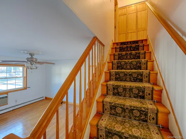 a view of staircase with white walls and a window