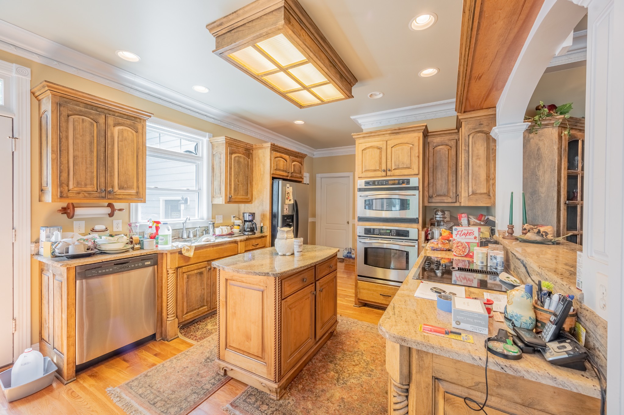 1476 Dripping Springs Road Winchester, TN 37398 - Photo 23 of 68 a kitchen with stainless steel appliances a stove a sink dishwasher and wooden cabinets with wooden floor
