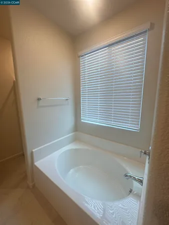 a bathroom with a bathtub and a window