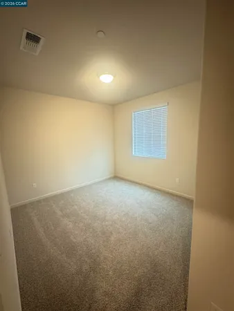a view of an empty room and a window