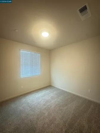 an empty room with a empty space and windows