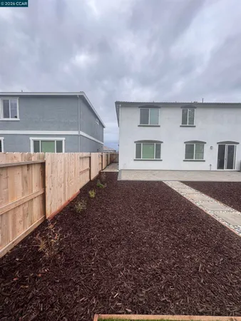 a view of house with yard and sitting area