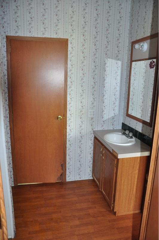 9960 Bellbrook Road Milton, FL 32583 - Photo 13 of 29 an empty room with wooden floor