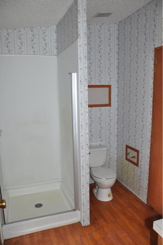 9960 Bellbrook Road Milton, FL 32583 - Photo 14 of 29 a bathroom with a toilet and a shower