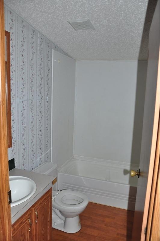 9960 Bellbrook Road Milton, FL 32583 - Photo 15 of 29 a bathroom with a granite countertop sink toilet and shower