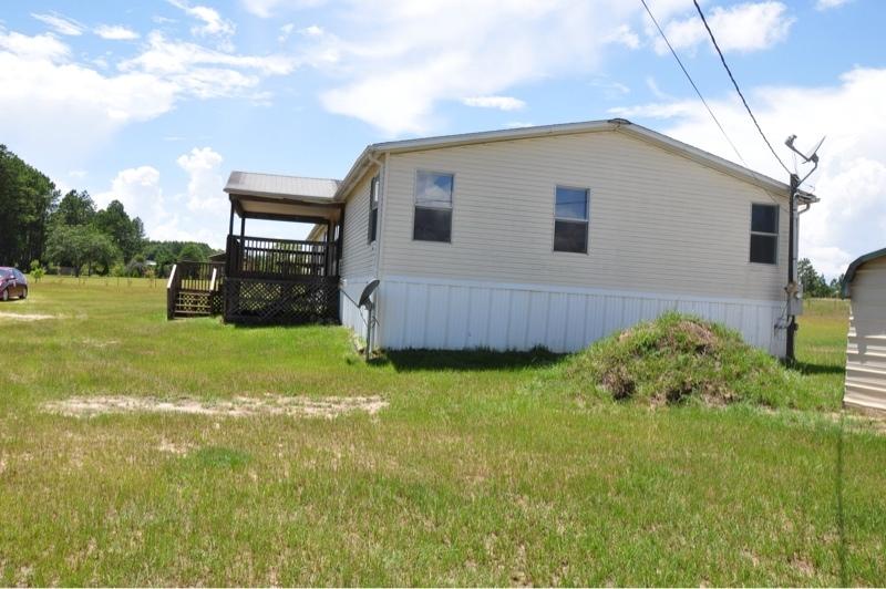 9960 Bellbrook Road Milton, FL 32583 - Photo 2 of 29 a view of backyard with barbeque grill and wooden fence