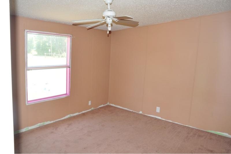 9960 Bellbrook Road Milton, FL 32583 - Photo 22 of 29 an empty room with a window and a fan
