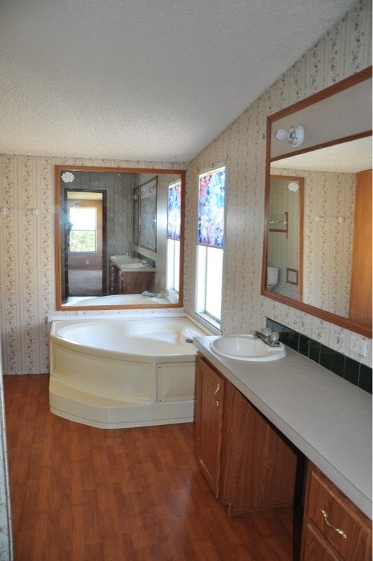 9960 Bellbrook Road Milton, FL 32583 - Photo 25 of 29 a view of kitchen island a sink wooden floor and living room view