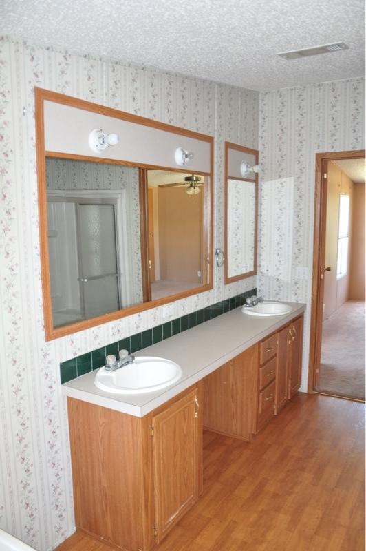 9960 Bellbrook Road Milton, FL 32583 - Photo 26 of 29 a bathroom with a sink and a mirror