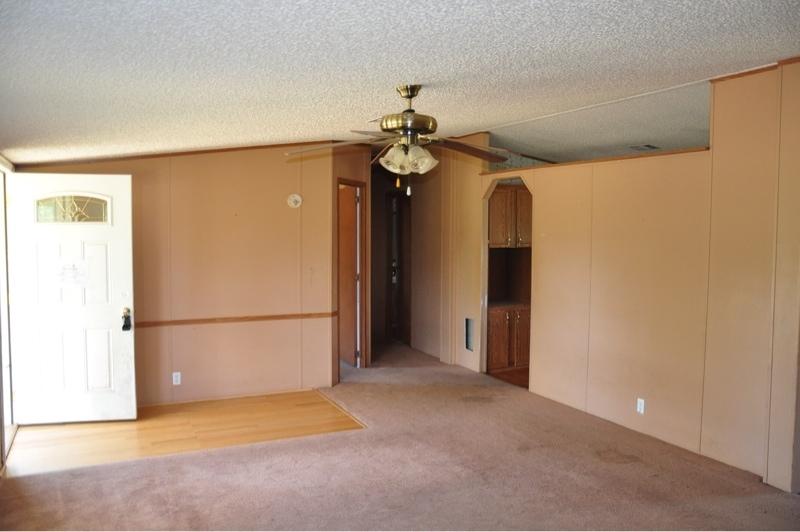 9960 Bellbrook Road Milton, FL 32583 - Photo 6 of 29 a view of a kitchen with a refrigerator and a ceiling fan