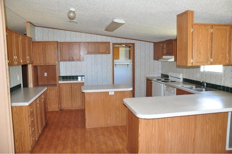 9960 Bellbrook Road Milton, FL 32583 - Photo 8 of 29 a kitchen with stainless steel appliances granite countertop a refrigerator a stove a sink and a microwave