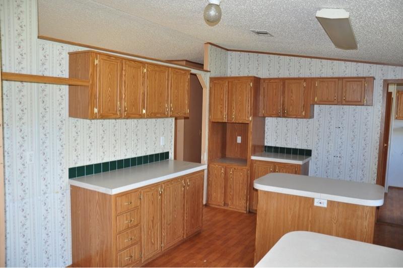 9960 Bellbrook Road Milton, FL 32583 - Photo 9 of 29 a kitchen with a sink a stove and a wooden cabinets