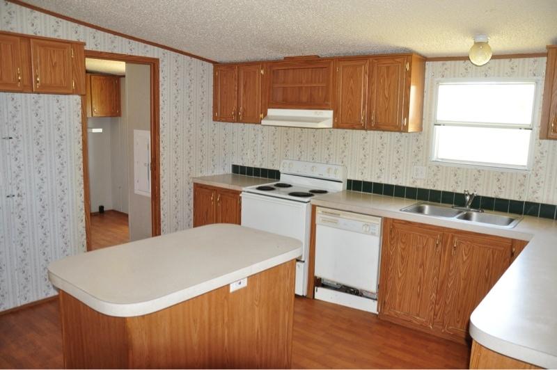 9960 Bellbrook Road Milton, FL 32583 - Photo 10 of 29 a kitchen with stainless steel appliances granite countertop a sink stove and refrigerator