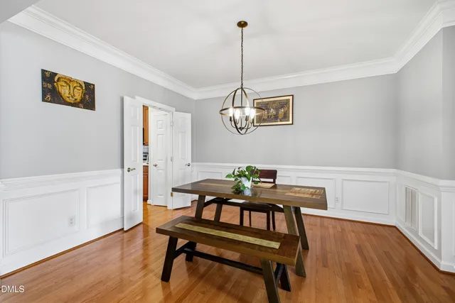 a view of a dining room with furniture wooden floor and a chandelier