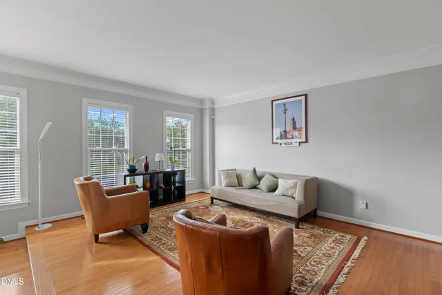 a living room with furniture and wooden floor