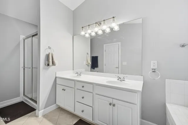a bathroom with a double vanity sink and a mirror