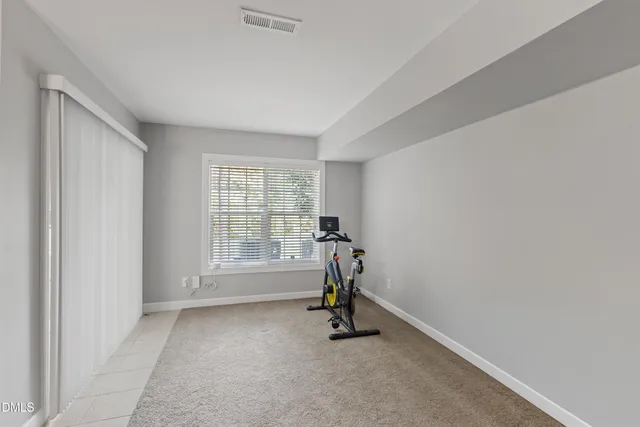 a view of room with window and a ceiling fan
