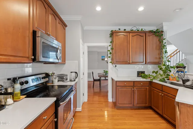 a kitchen with stainless steel appliances a sink stove and cabinets