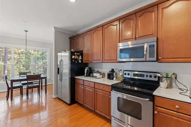 a kitchen with a stove a sink and a microwave