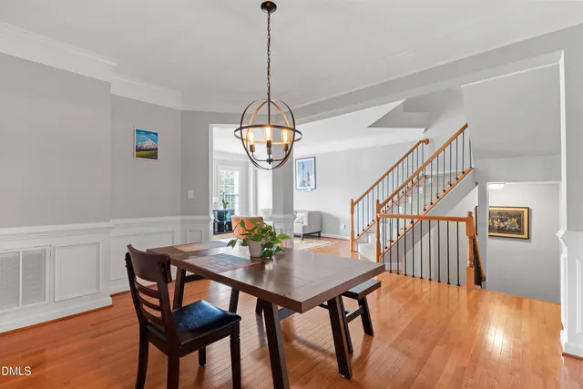 a view of a dining room with furniture wooden floor and chandelier