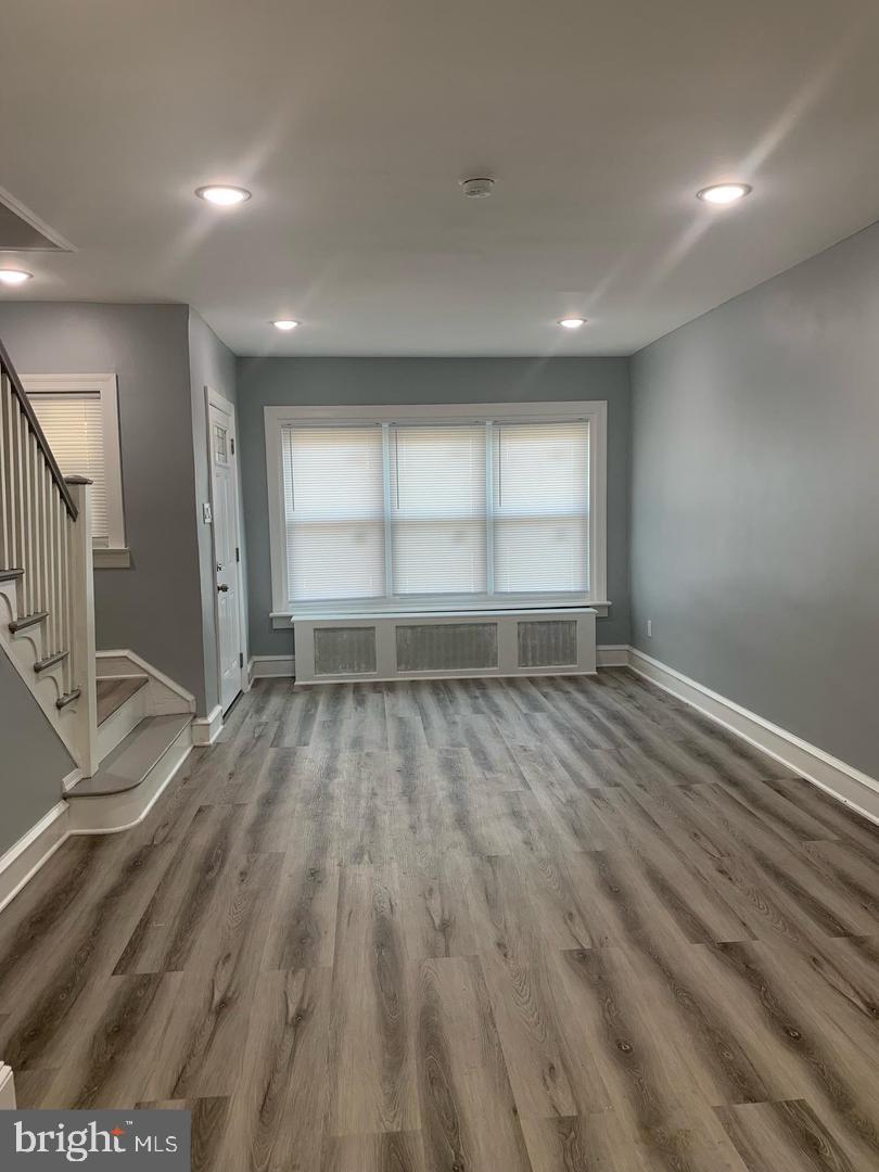 912 Anchor Street Philadelphia, PA 19124 - Photo 11 of 14 an empty room with wooden floor and windows