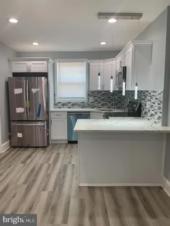 a kitchen with stainless steel appliances granite countertop a sink and a stove
