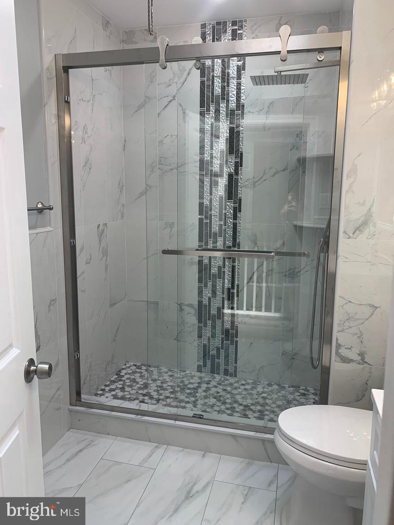 912 Anchor Street Philadelphia, PA 19124 - Photo 5 of 14 a bathroom with a shower and a toilet