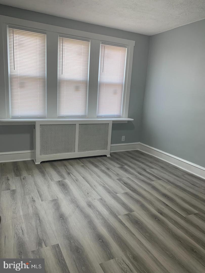 912 Anchor Street Philadelphia, PA 19124 - Photo 6 of 14 an empty room with wooden floor and windows