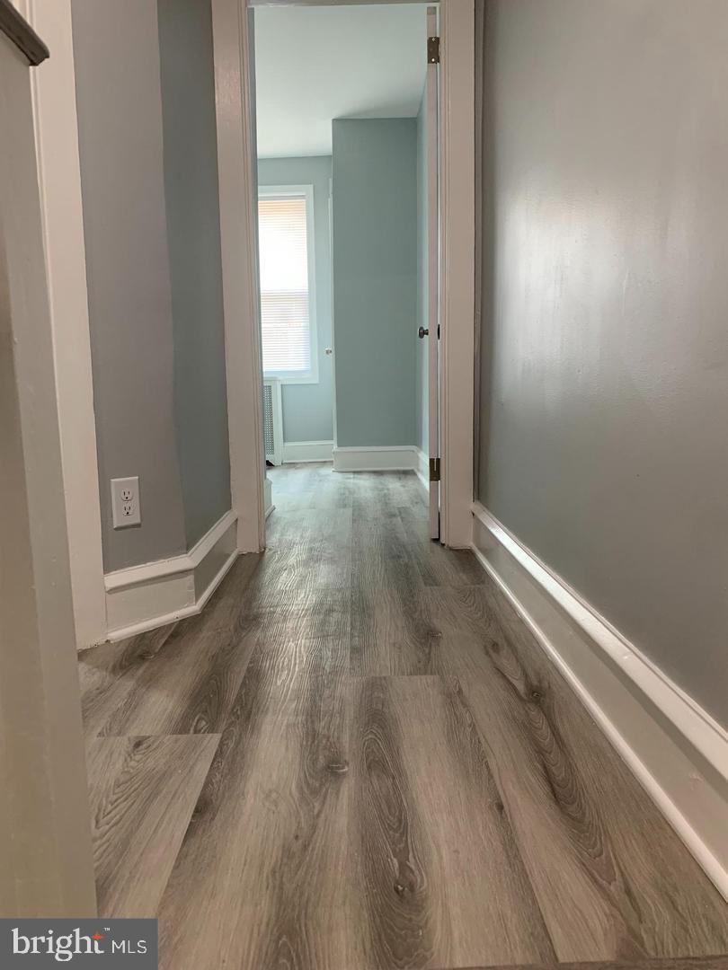 912 Anchor Street Philadelphia, PA 19124 - Photo 8 of 14 an empty room with wooden floor and windows