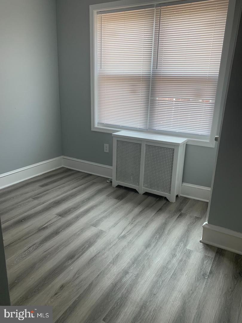 912 Anchor Street Philadelphia, PA 19124 - Photo 10 of 14 an empty room with wooden floor and windows