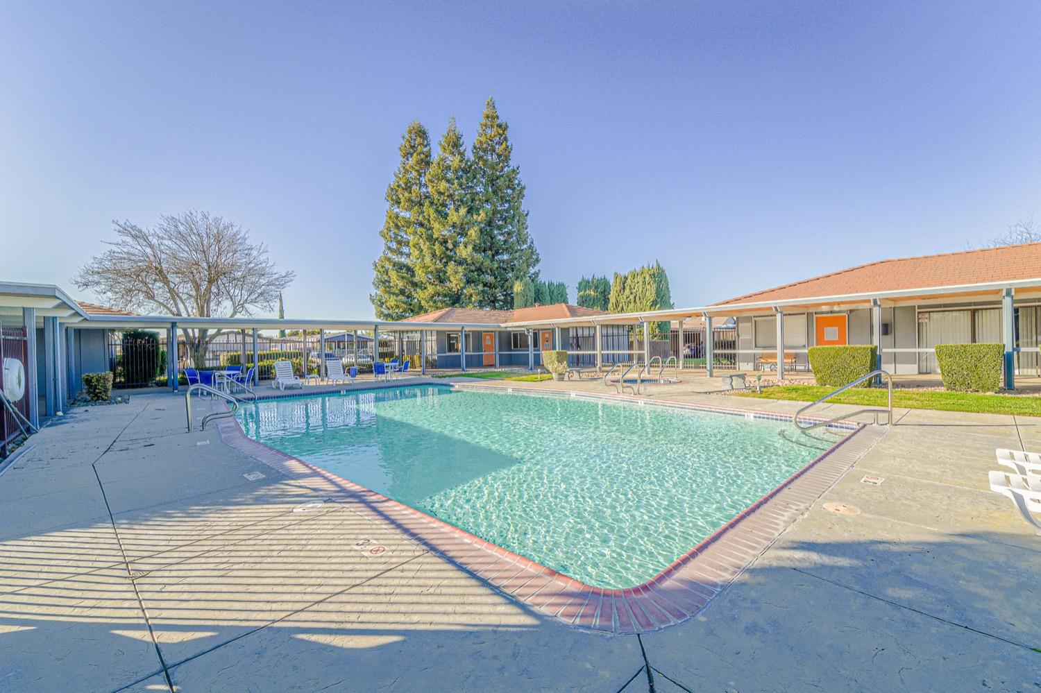 167 Clipper Lane Modesto, CA 95356 - Photo 12 of 23 a view of a house with a swimming pool