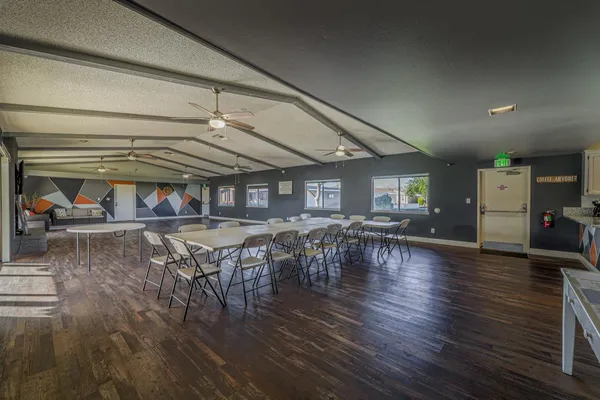 a view of a dining room with furniture water view and wooden floor