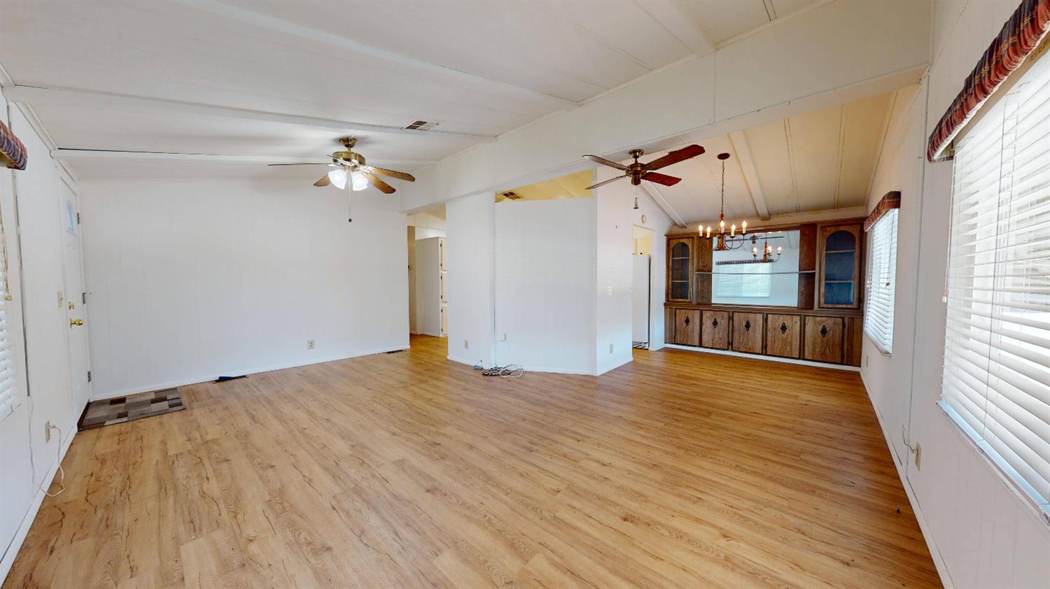 167 Clipper Lane Modesto, CA 95356 - Photo 4 of 23 a view of a livingroom with wooden floor and a ceiling fan