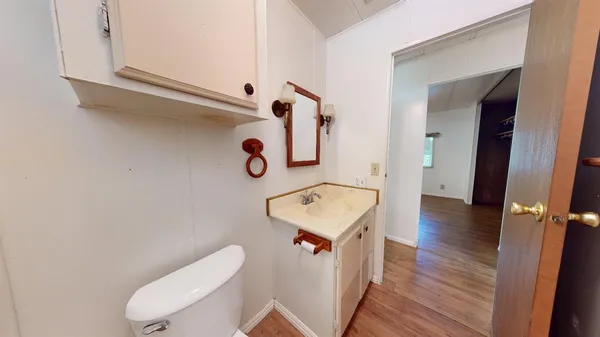 a bathroom with a toilet sink and mirror
