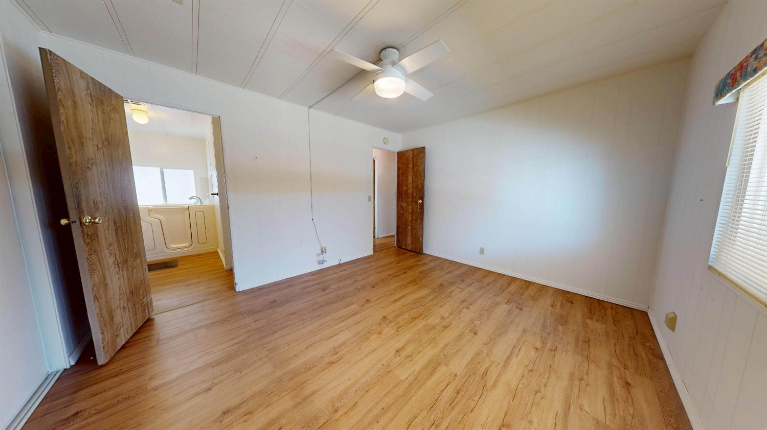 167 Clipper Lane Modesto, CA 95356 - Photo 7 of 23 wooden floor in an empty room with a window