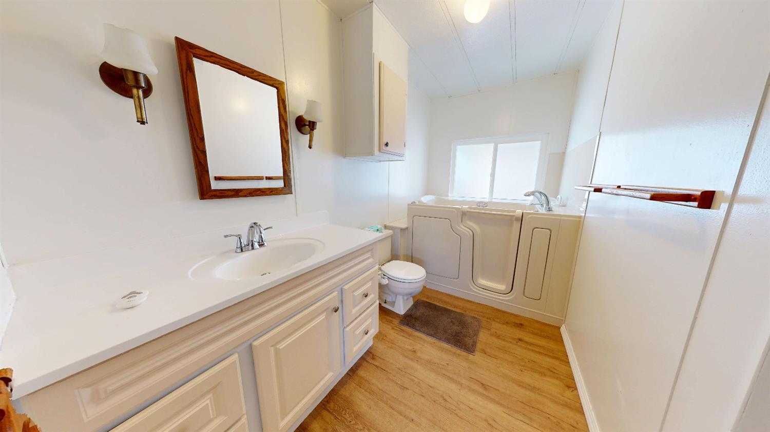 167 Clipper Lane Modesto, CA 95356 - Photo 8 of 23 a bathroom with a sink a toilet and a mirror