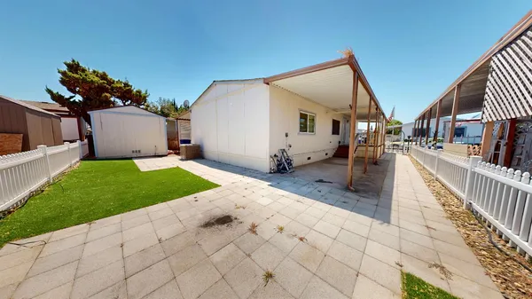 a view of a house with a yard and pathway