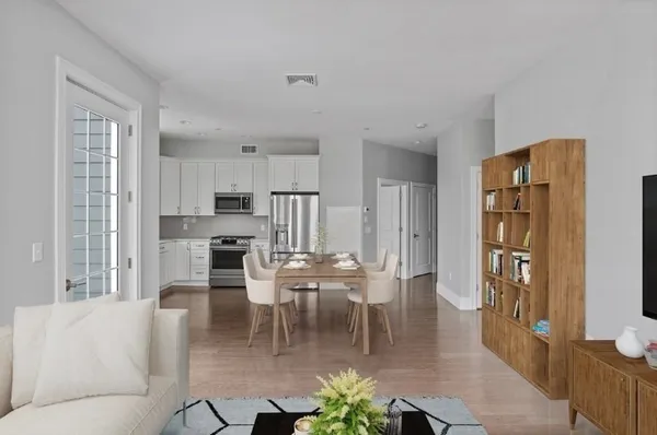 a dining room with furniture and a kitchen view