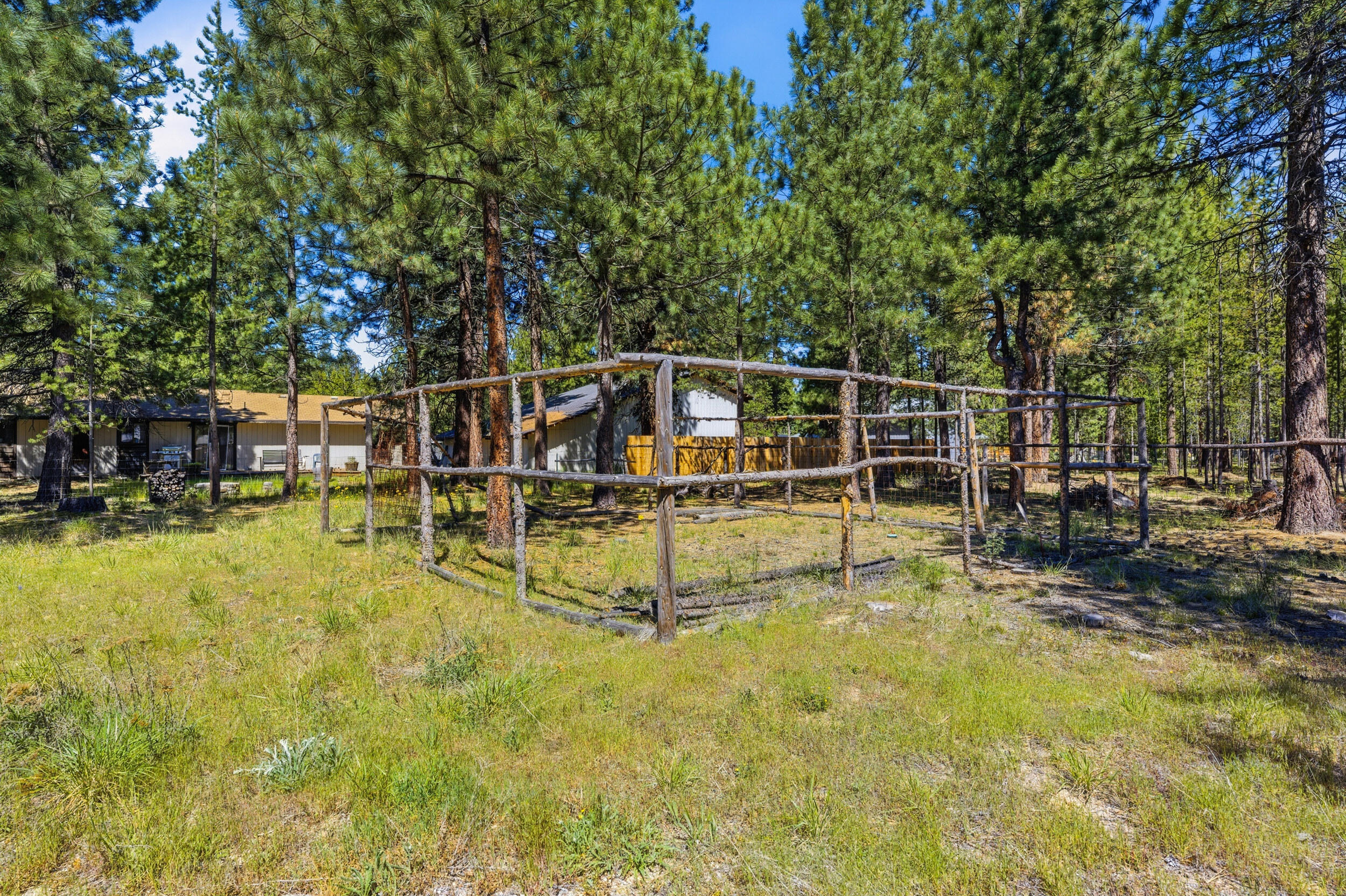50868 Doe Loop La Pine, OR 97739 - Photo 42 of 51 a view of a swimming pool with a bench and trees