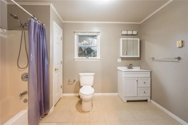 an empty room with a ceiling fan and window