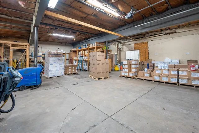 a kitchen with stainless steel appliances granite countertop a refrigerator a sink dishwasher a stove and white cabinets with wooden floor