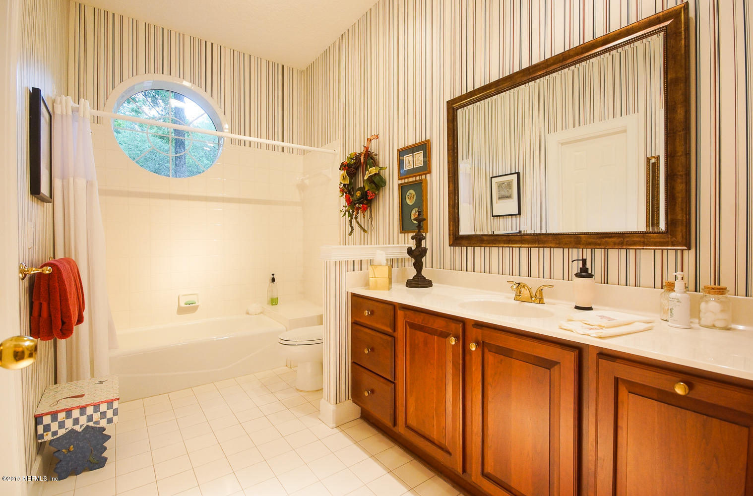 829 Queens Harbor Boulevard Jacksonville, FL 32225 - Photo 19 of 42 a bathroom with a sink a vanity and a mirror