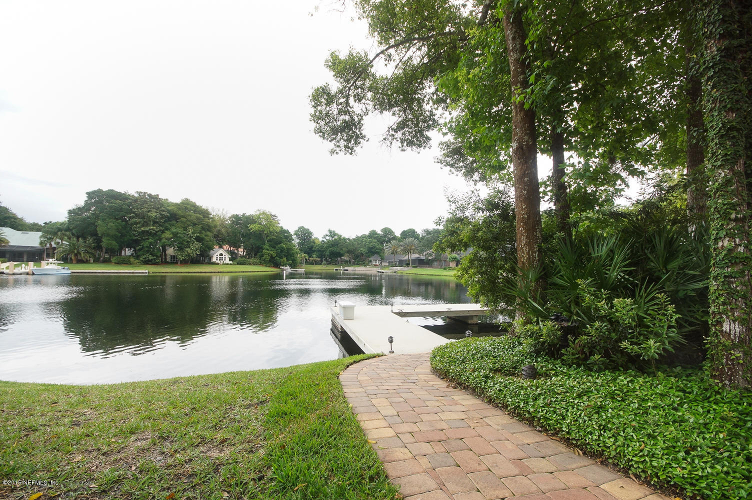 829 Queens Harbor Boulevard Jacksonville, FL 32225 - Photo 35 of 42 a view of a lake with a yard and potted plants