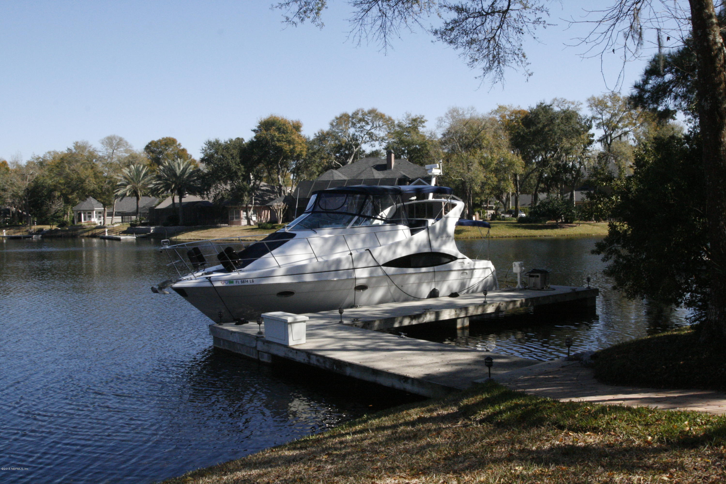 829 Queens Harbor Boulevard Jacksonville, FL 32225 - Photo 36 of 42 a view of a swimming pool with a yard and plants