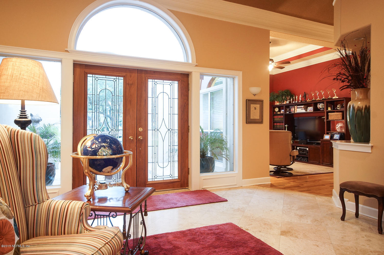829 Queens Harbor Boulevard Jacksonville, FL 32225 - Photo 5 of 42 a living room filled with furniture and a floor to ceiling window