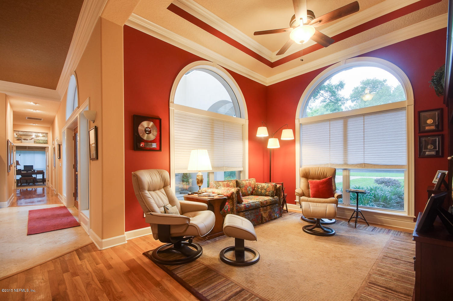 829 Queens Harbor Boulevard Jacksonville, FL 32225 - Photo 9 of 42 a living room with furniture a fireplace and large windows