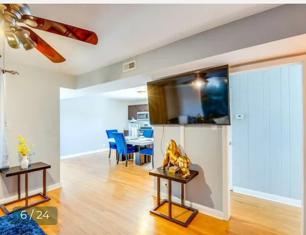 a living room with furniture rug and wooden floor