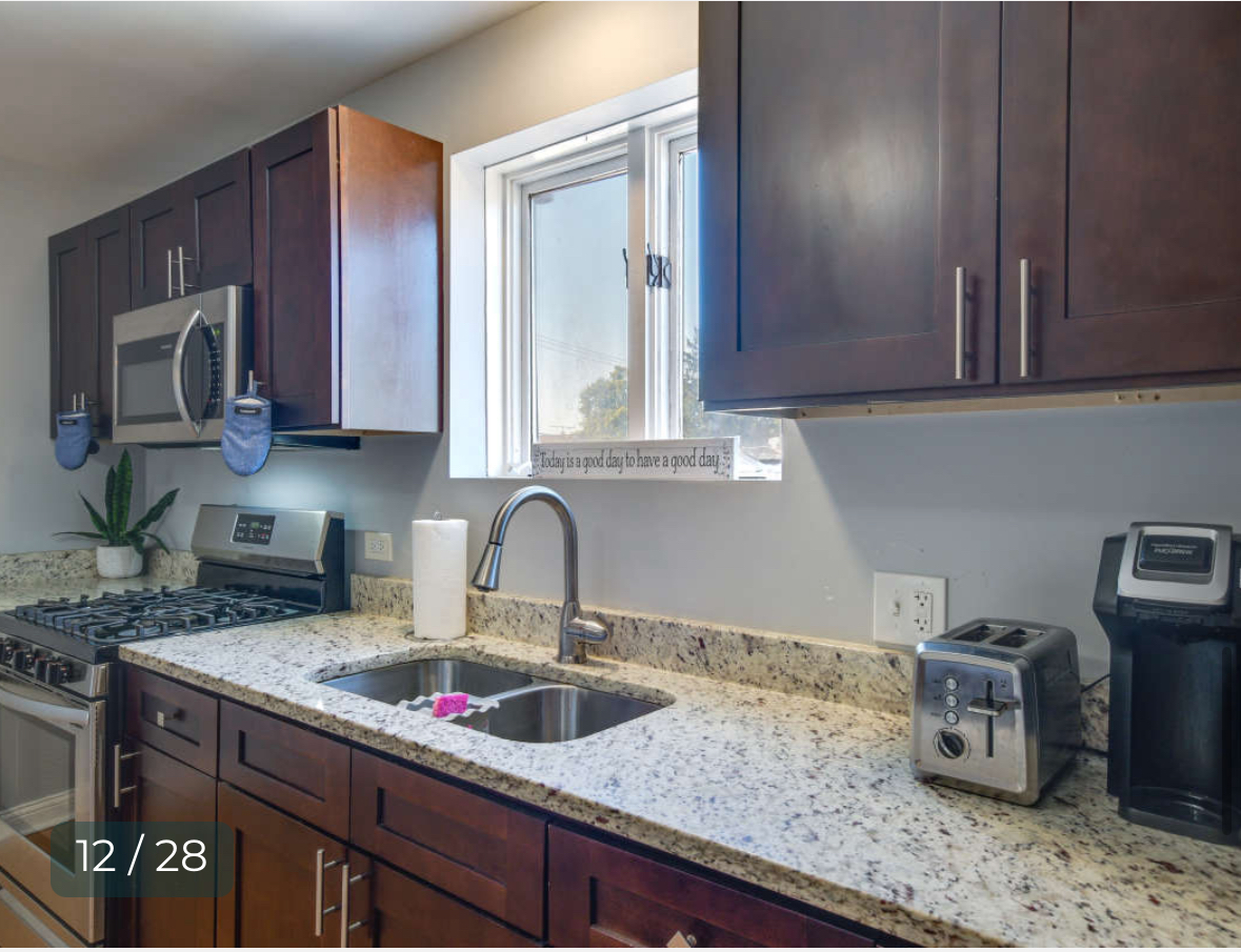 8136 South Kedzie Avenue, Unit 201 Chicago, IL 60652 - Photo 6 of 9 a kitchen with granite countertop a sink and a stove top oven