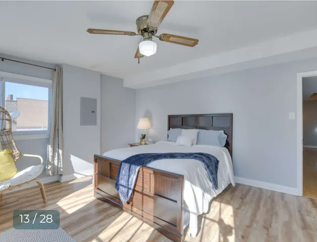 a bed sitting in a bedroom next to a window